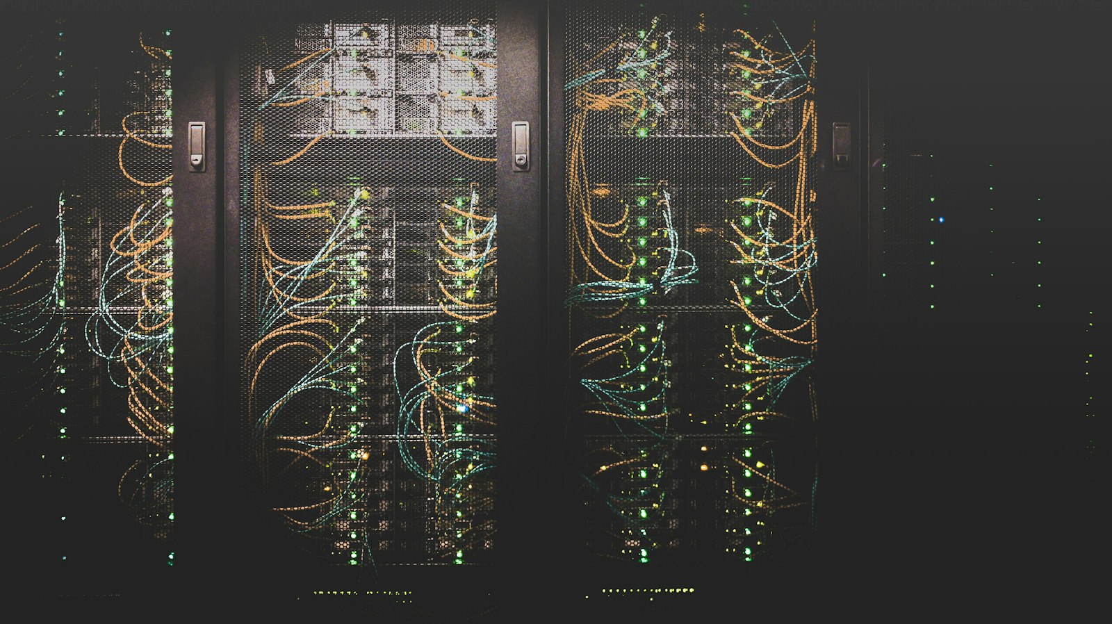 Server racks with bundles of network cables and status lights